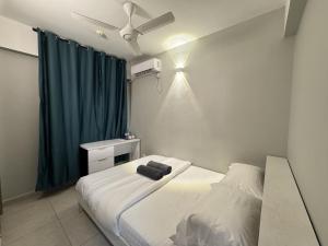 a bedroom with a bed and a ceiling fan at Araam Retreat Deluxe in Male City