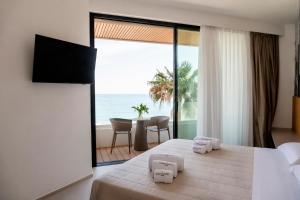 a bedroom with a bed with a view of the ocean at Terradamare Suites in Monopoli