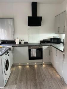 a kitchen with a washing machine and a washer at The Lenton House in Nottingham