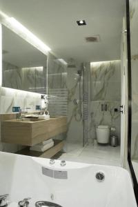 a white bathroom with a tub and a sink at فندق راسيا in Medina +23 photos