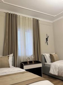 a hotel room with two beds and a window at Modern Luxury Apartment-City Center-Walk Anywhere in Durrës +11 photos