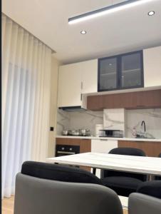 a kitchen with a table and chairs in a room at Modern Luxury Apartment-City Center-Walk Anywhere in Durrës