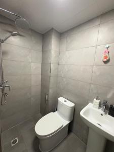 a bathroom with a toilet and a sink at Araam Retreat Deluxe in Male City