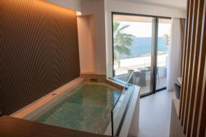 a swimming pool in a house with a view of the ocean at Terradamare Suites in Monopoli