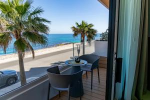 a balcony with a table and chairs and the ocean at Terradamare Suites in Monopoli