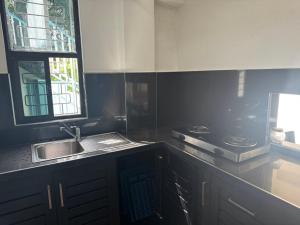 a kitchen with a sink and a window and a sink at Holiday Home in Lautoka