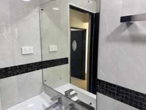a bathroom with a sink and a mirror at Holiday Home in Lautoka