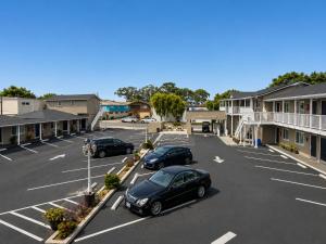 two cars parked in a parking lot in front of a motel at Rockview Inn and Suites - Morro Bay CA in Morro Bay