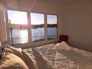 a bedroom with a bed with a view of the water at The View in French Village