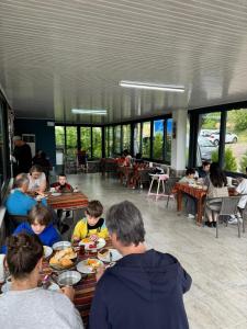 a group of people sitting at tables in a restaurant at Paradise House in Pamukkale