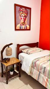 a bedroom with a bed and a painting on the wall at La Casa Rustica in Puerto Chicama