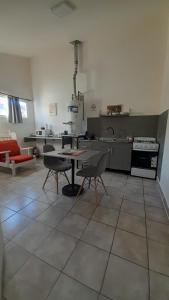 a kitchen with a table and chairs in a room at Departamento Olivia in Ushuaia +7 photos