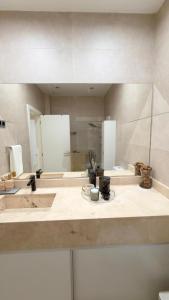 a bathroom with two sinks and a large mirror at 3 Ls APARTAMENTO in Luanda