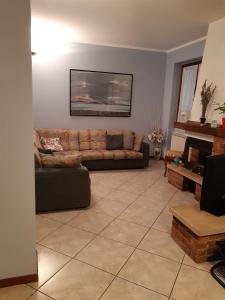 a living room with a couch and a fireplace at Casa Marina in Omegna