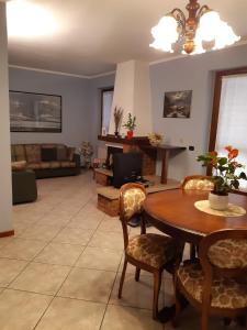 a living room with a table and chairs and a couch at Casa Marina in Omegna