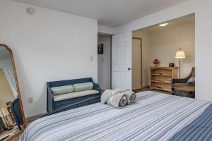 a bedroom with a large bed with two towels on it at 2 Mins from Airport 1 BDR with Large Backyard in Anchorage