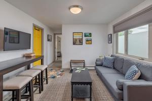 a living room with a couch and a table at 2 Mins from Airport 1 BDR with Large Backyard in Anchorage +18 photos
