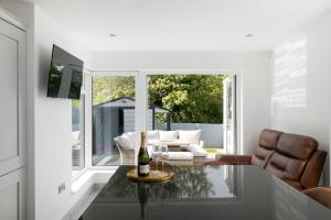 a living room with a bottle of wine on a table at Castlecroft House with Hot Tub in Dungiven