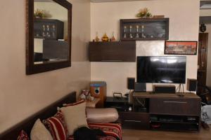 a living room with a tv and a couch at Marrakech Sakan Annakhil im6 n31 in Marrakesh