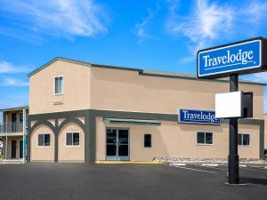 a building with a sign in front of it at Travelodge by Wyndham Barstow in Barstow +9 photos