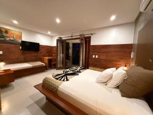 a bedroom with a large bed and a bathroom at Pousada Oasis Paracuru in Paracuru