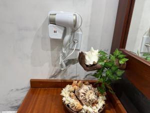 a phone and a plant on a table at Pousada Oasis Paracuru in Paracuru