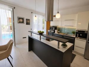 a kitchen with a counter top in a room at Villa Igalo Splitska - Private Pool & Sea View in Splitska