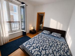 a bedroom with a bed and two windows at Villa Igalo Splitska - Private Pool & Sea View in Splitska
