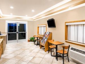 a living room with a table and chairs at Travelodge by Wyndham Barstow in Barstow