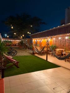 a patio with a hammock and a playground at night at Departmento Grande in Puerto Chicama