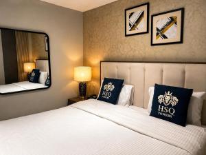 a bedroom with a bed with two pillows and a mirror at HSQ Towers in Murree