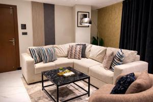 a living room with a couch and a table at HSQ Towers in Murree