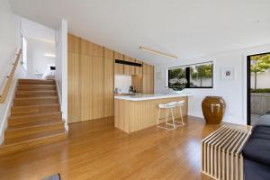 a kitchen and a living room with a couch and a table at No.8 Queenstown in Queenstown