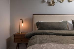 a bedroom with a bed and a night stand with a lamp at Modern Downtown Studio - King Bed - Inlet Views in Anchorage +16 photos
