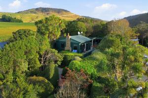 an aerial view of a house with trees and bushes at Private seaside couples hideaway in Kaka Point