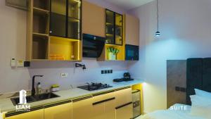 a kitchen with yellow cabinets and a sink at Studio Apartment -LIAM Signature Akowonjo Egbeda in Akinde