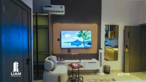 a living room with a tv on a wall at Studio Apartment -LIAM Signature Akowonjo Egbeda in Akinde