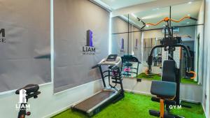 a gym with a treadmill and a elliptical machine at Studio Apartment -LIAM Signature Akowonjo Egbeda in Akinde +4 photos