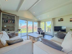 a living room with two couches and a tv at Zout en Peper in Kattendijke