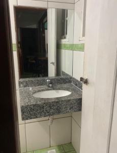 a bathroom with a sink and a mirror at Casa vicentina in Tiradentes +28 photos