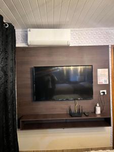 a large flat screen tv on a wall at Quarto Aconchegante N 3 in Rio Negro