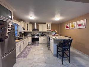 a large kitchen with white cabinets and a large island at Casa Rosarito beach in Rosarito Beach