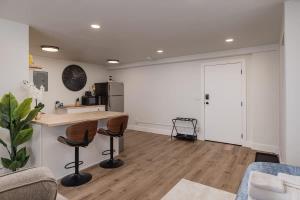 a kitchen with a counter and two stools at Stylish Downtown Studio - Free Parking plus Kitchen in Anchorage