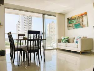a living room with a table and chairs and a couch at BlueMar Cartagena in Cartagena de Indias