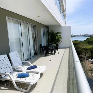 a balcony of a house with two chairs and a table at BlueMar Cartagena in Cartagena de Indias