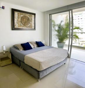 a bedroom with a bed and a large window at BlueMar Cartagena in Cartagena de Indias +39 photos