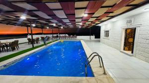 a pool in a building with a restaurant at La mira chalet in Madaba