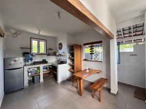 a kitchen with a wooden table and a counter at Santai Retreat in Kuta Lombok