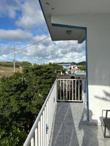 a balcony with a white fence and a bush at Combate el Carribe Paradise in Cabo Rojo +34 photos