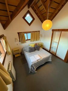 a bedroom with a bed in a room with a ceiling at Inlandsis Aparts in El Chalten